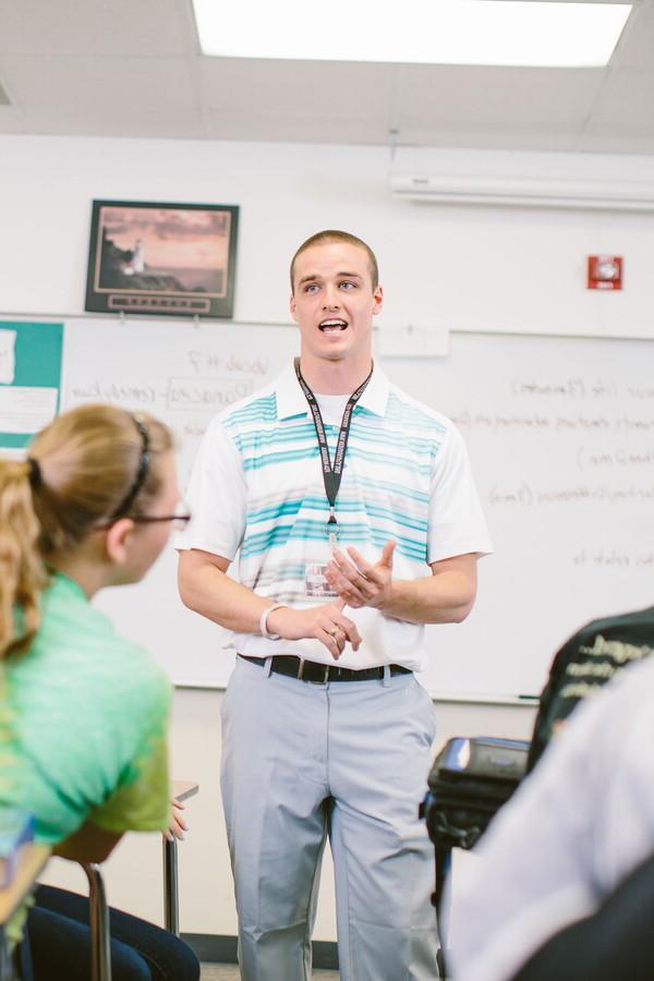 Male student teacher in front of a class